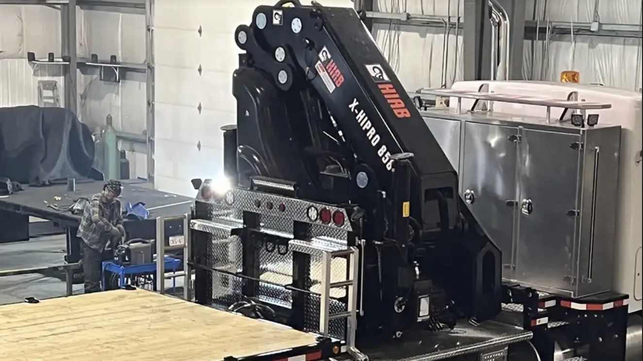 View of picker crane on truck at Core Fabrication facility following design of deck with preengineered mounting points