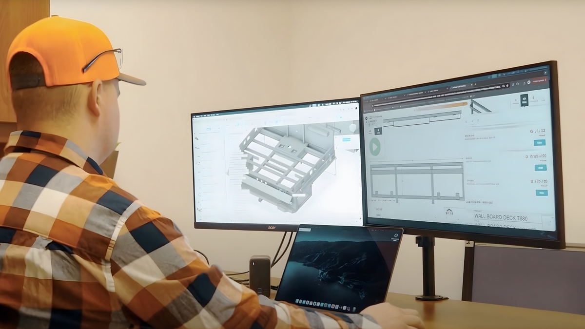Core Fabrication employee looking over digital renderings of planned project